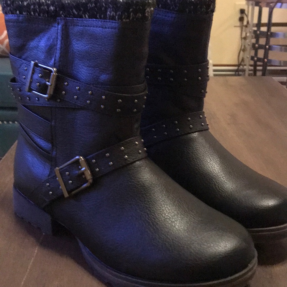 Black combat boots with studded buckle.